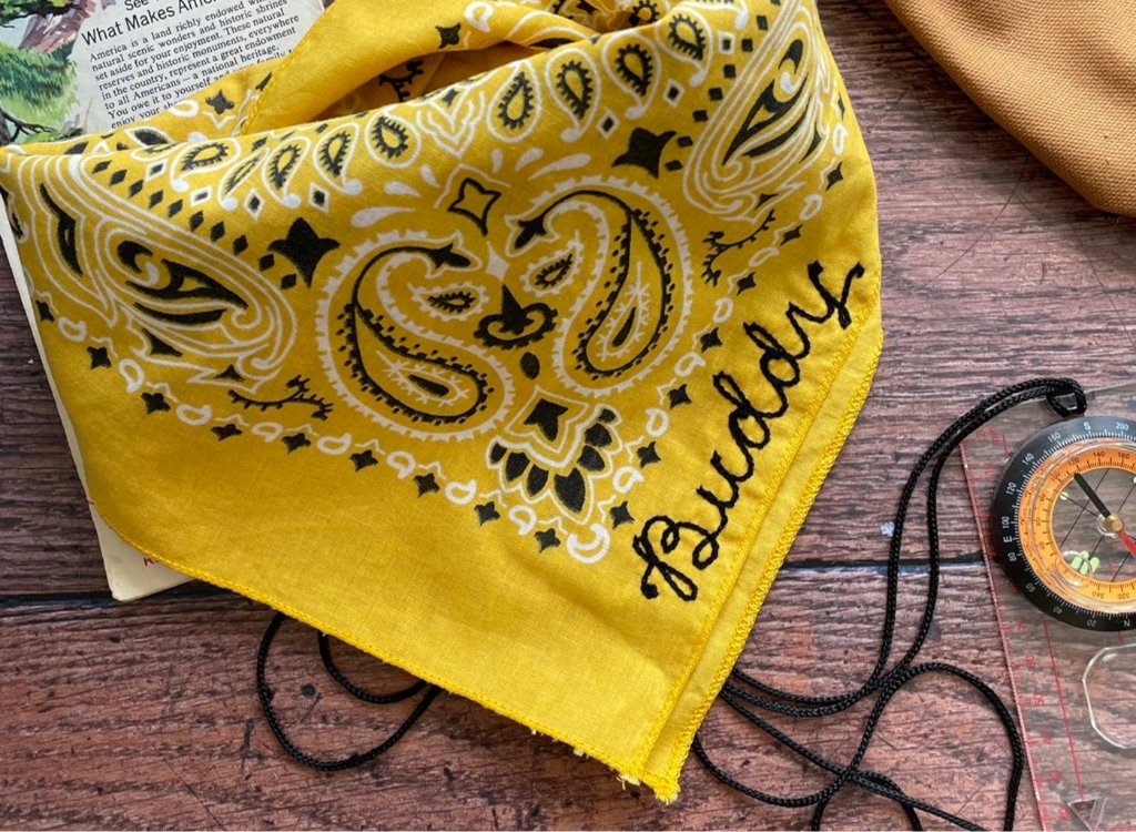 A yellow personalised bandana with the wording Buddy