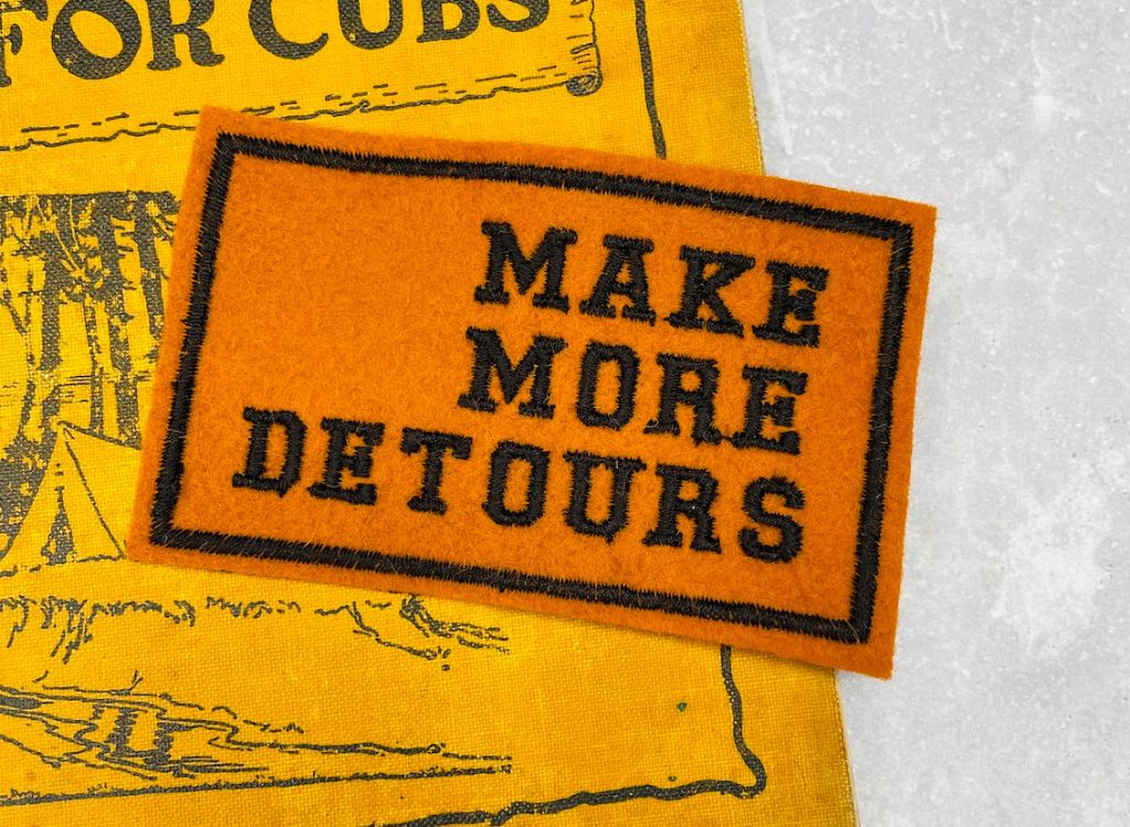 A make more detours patch in orange and black