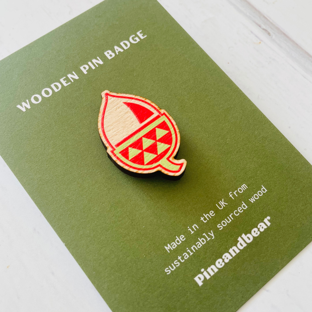 wooden pin badge in an acorn design