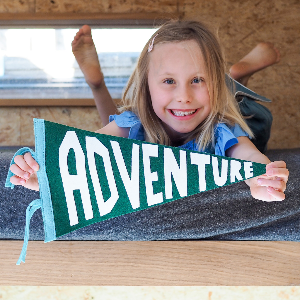 Little girl holding adventure pennant