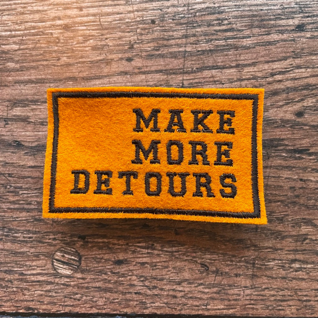 Make more detours embroidered patch in orange and black