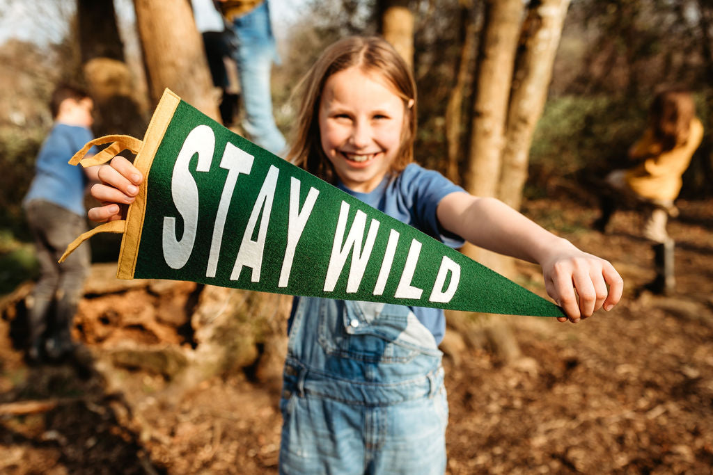 Girlholding a stay wild pennant flag