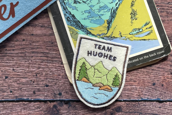 An embroidered adventure patch with a map