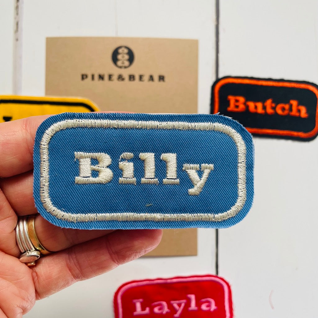 custom embroidered name patch in blue and cream
