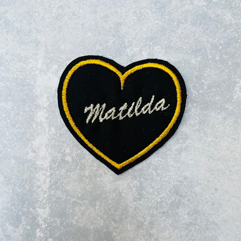 Custom heart patch in black and yellow.