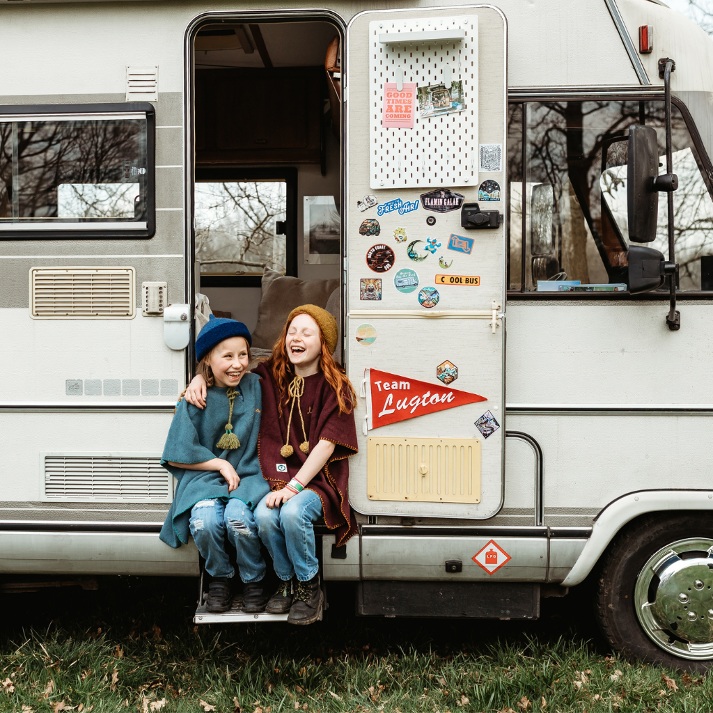 Two girls sitting in campervan