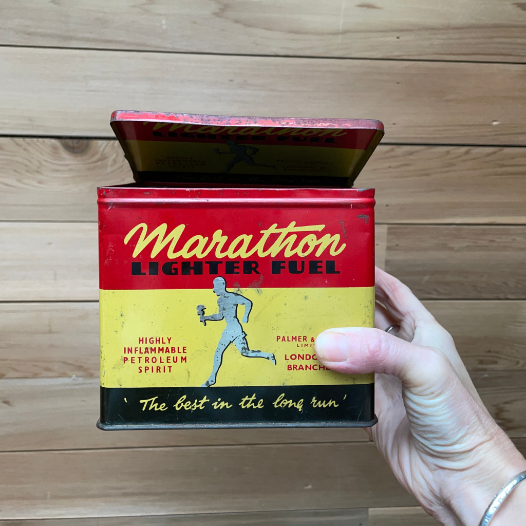 A vintage marathon lighter fuel tin