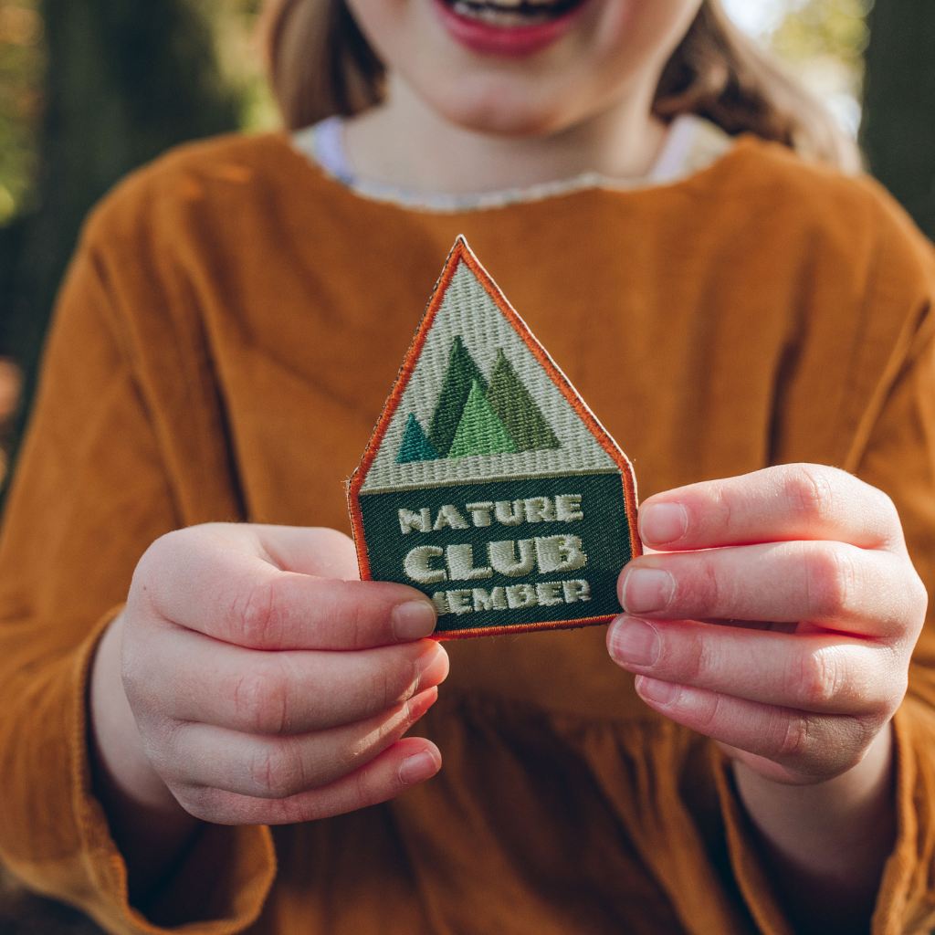 Child holding Nature Club Member Embroidered Adventure Patch